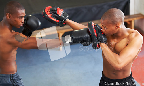 Image of Fighting, coaching and boxer with personal trainer for workout, power or training challenge. Strong body, spar partner and black man in gym with fist up, fitness and confidence in competition boxing.