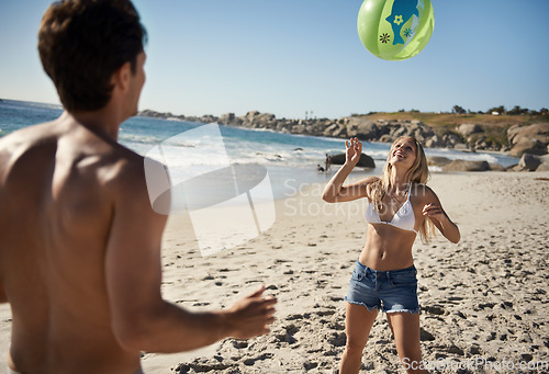 Image of Couple, ball playing and fun by beach in summer with love, care and support together on a holiday. Happy, vacation and date by the sea in Miami with freedom and travel by the ocean on a trip outdoor