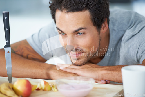 Image of Man, fruit and kitchen diet at breakfast or health nutrition, eating vitality or banana for protein. Male person, yogurt and apple wellness meal or hungry vegan preparation, fiber as morning vitamins