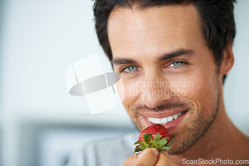 Image of Home portrait, happy man and eating strawberry for morning diet, healthy lifestyle or fruit benefits, wellness or breakfast. Natural detox, nutrition food and face of person smile for antioxidants