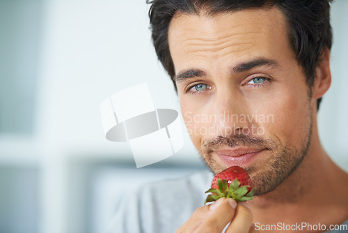 Image of Portrait, man and eating strawberry, healthy food or organic vegan product for weight loss benefits, wellness or breakfast. Vitamin C, headshot and face of male nutritionist with fruit nutrition meal