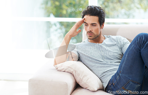 Image of Man, thinking and sofa for unhappy in home or lonely grief mourning, broken heart or stress. Male person, sad thoughts on couch for depressed risk or loss problem from anxiety, mental health or fail