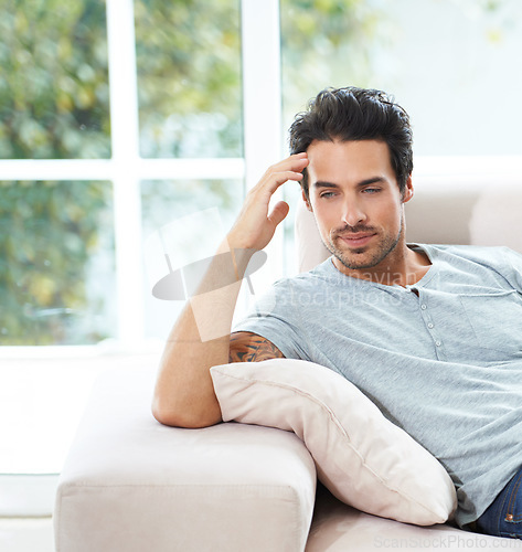 Image of Man, thinking and sofa for sad grief in home for lonely mourning, broken heart or stress. Male person, unhappy thoughts on couch for depressed risk or loss problem from anxiety, mental health or fail