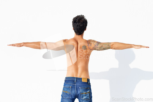 Image of Back, muscle and shirtless with man, stretching and promotion isolated on a white studio background. Person, guy and model with exercise, jeans or fitness with health, mockup space and body with care