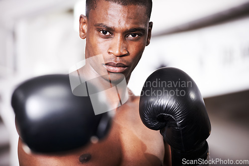 Image of Boxing, gloves and punch, portrait of black man with fitness and power for training challenge. Strong body, muscle and hands of boxer in gym, athlete with fist up and confidence in competition fight.