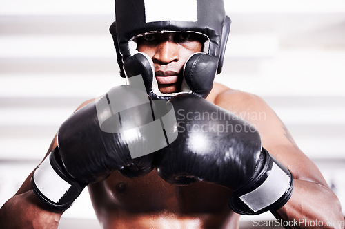 Image of Boxing, gloves and headgear, portrait of black man in gym in fitness training, power and workout challenge. Strong body, fighting and boxer padded safety helmet, fearless and confident in competition