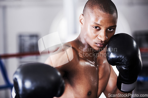 Image of Boxing, gloves and punch, portrait of black man with fitness and power training challenge in gym. Strong body, muscle workout and boxer in club, fist of athlete with confidence, competition and fight