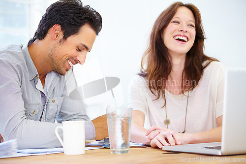 Image of Team, funny business people and discussion at table in office, collaboration or planning strategy in startup. Creative, coworking and employees brainstorming or designers laugh in meeting on laptop