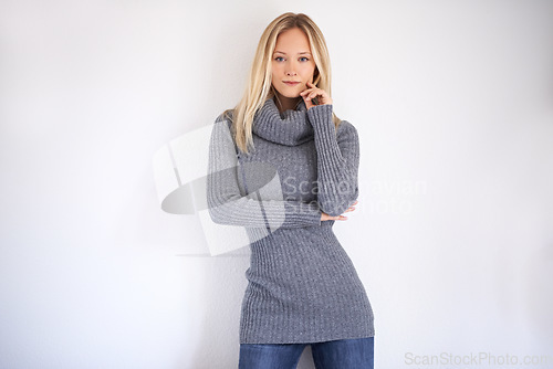 Image of Woman, portrait and serious in studio with fashion, winter style or trendy outfit with hands. Cool, face and assertive with person on mock up space with confidence, pride and edgy on white background