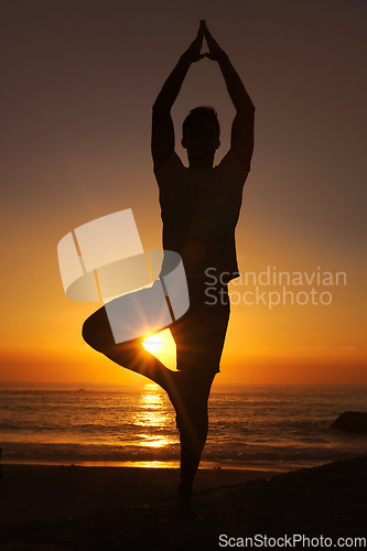 Image of Silhouette, man and praying with hands for yoga, health and wellness on beach with sunset and zen. Person, shadow and pilates or namaste for balance, mindfulness and healthy body by ocean or sea