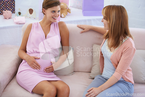 Image of Women, babyshower and hands on stomach, living room couch and happy with baby moving. Pregnant lady, smile and excited for pregnancy, motherhood and celebrating child with friends in family home