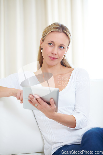 Image of Mature woman, tablet and thinking in home, serious face and living room couch. Social media, technology and communication for scrolling, vision and idea with connection, streaming and contemplating