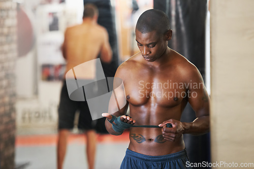 Image of Man, boxing and hand wrap as fighter for workout exercise club, punch practice or coaching. Black person, wrist support or tape as health fist or athlete bandage for gym sports, challenge for defence