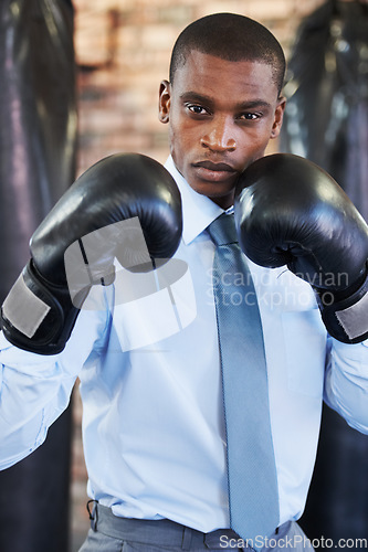 Image of Man, portrait and boxing gloves in suit confident for manager job, ready for business or corporate competition. Black person, face and fighter gear for office achievement, career promotion at work