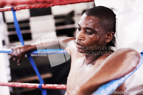 Image of Man, boxing ring and sweat or tired in gym for fitness exercise, professional athlete and rest. Black person, exhausted and competition punch practice or goals training, mma fight in arena battle