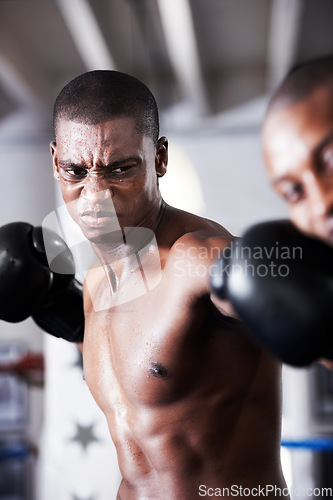 Image of Fight, black man and boxer with hit in ring together for fitness, power strike and training challenge. Strong body, punch in face and fearless athlete in gym with action and confidence in competition