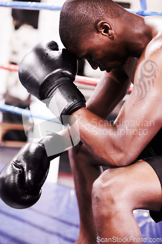 Image of Man, boxer and face down in boxing ring, sweat and gloves for workout, fighter and strong. Exercise, sports and train for power, self defense and concentration for challenge, mma and fighting skills