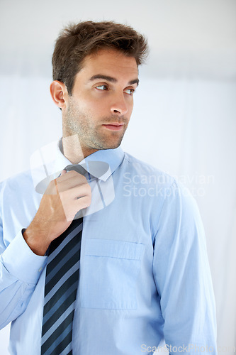 Image of Job opportunity, tie and a business person getting ready for work in studio on a white background. Corporate, company and dressing with a young man adjusting his outfit for a professional career