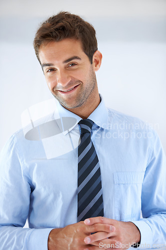 Image of Businessman, portrait and happy in office for career, professional and employee at corporate job. Entrepreneur, face and person for smile, confidence and pride with calm expression or hands at work