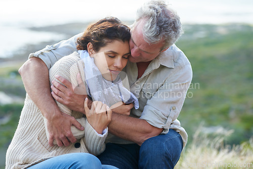 Image of Couple, face and smile outdoor with hug for romance, love and relationship in nature with relaxing. Mature, man and woman or embrace with happy, peace and comfort for bonding, honeymoon and support