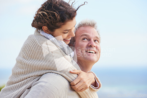 Image of Mature couple, happy and outdoor on vacation, travelling and weekend for enjoying holiday. Man, woman and bonding together with smile, marriage and commitment with affection, blue skies and joyful