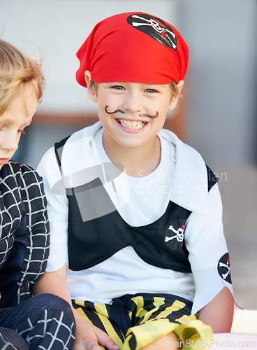 Image of Portrait, halloween and a boy in a pirate costume for a trick or treat tradition outdoor in his neighborhood. Kids, smile and a happy young male child in a fantasy outfit for holiday celebration