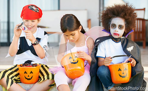 Image of Children, halloween and candy bucket for holiday fun or vampire dress up, fairy or pirate role play. Friends, group and pumpkin basket as dessert or trick or treat celebration, fantasy or development