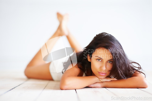 Image of Sexy woman in underwear, relax and portrait on floor with natural beauty aesthetic and white background. Fashion, body care and model in lingerie with glow, wellness and relax in sensual freedom