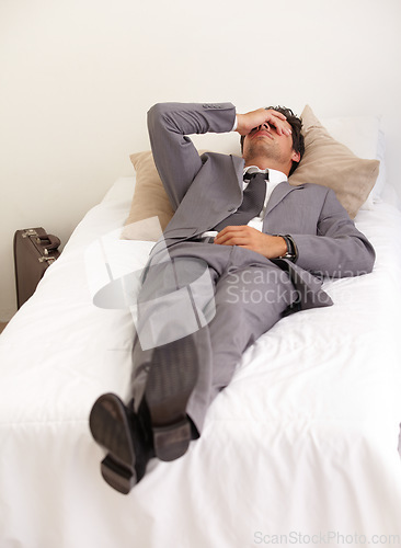 Image of Depression, bed and tired business man with burnout, stress or mistake or mental health crisis at home. Anxiety, fatigue or male workaholic in bedroom with headache, vertigo or frustrated by insomnia