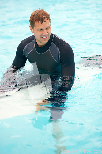 Image of Confident, man or surfer in ocean with board, health fitness or happy in summer with water sports. Person, smile and relax wellness in caribbean beach with vacation, adventure and wetsuit for workout