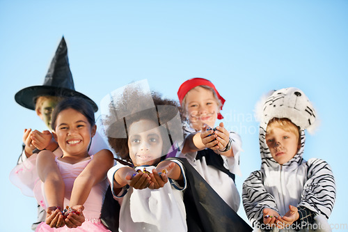 Image of Children, hands and portrait for halloween costume for sweet candy asking, trick or treat for fantasy. Friends, group and dress up as witch or pirate for holiday, kid development on sky background