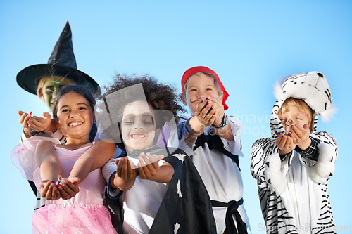 Image of Children, group and hands in halloween costume for sweet candy asking, trick or treat for fantasy. Friends, smile and dress up as witch or pirate for holiday fun, kid development on sky background