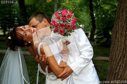 Image of Groom kissing bride 