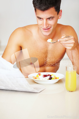 Image of Happy, eating and young man with fruit salad at his home for healthy breakfast or snack. Smile, wellness and male person from Canada enjoying yoghurt for meal in the kitchen at his modern apartment.