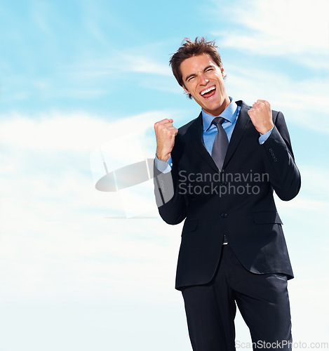 Image of Business man, fist pump and smile for success, celebration and excited for achievement or victory. Happy businessperson, promotion and bonus or salary increase, opportunity and blue sky background