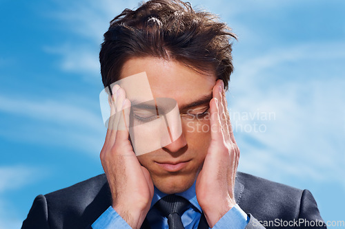 Image of Businessman, headache and stress or burnout, mental health and frustrated by debt and audit. Professional, male person and migraine or fatigue, anxiety and massage temple or brain fog and blue sky