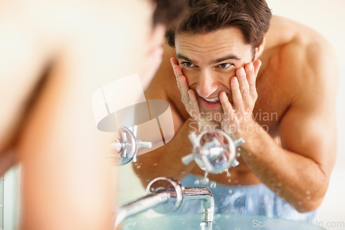 Image of Man, washing and face with water in bathroom for clean, hygiene or germs in morning. Happy person, hands and soap for skincare, routine or dermatology in smile in home with reflection, fresh or care