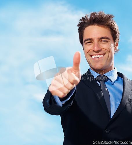 Image of Business man, thumbs up and portrait for success, support or like emoji on blue sky background for real estate. Face of professional realtor, corporate businessman or agent for good job, okay or yes