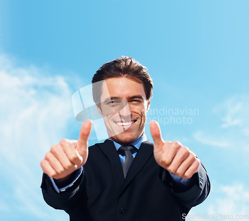 Image of Businessman, thumbs up and portrait for success, support or like emoji on blue sky background for real estate. Face of professional realtor, business man or corporate agent for good job, okay or yes