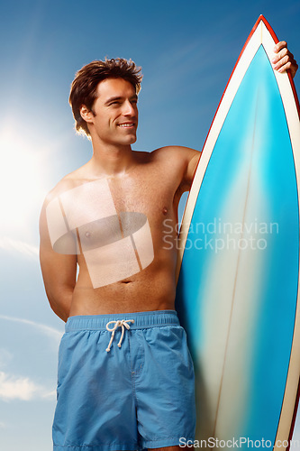 Image of Man, surfboard and sunshine summer by sky with smile for fitness, health and training. Athlete, surfer and board for holiday, happy and thinking outdoor for wellness, workout and exercise in nature