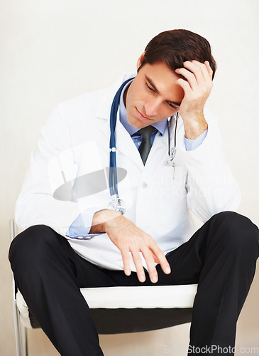 Image of Burnout, mental health and sad doctor, man or surgeon depressed over medical mistake, wellness services crisis or disaster. Hospital risk, cardiology fail and tired from clinic healthcare work