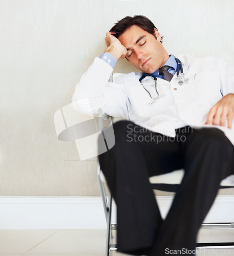 Image of Burnout, fatigue and sleeping doctor, man or surgeon rest after medical cardiology, wellness services or exhausted. Eyes closed, relax medic and professional nurse tired in clinic healthcare hospital