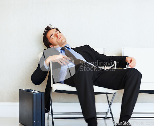 Image of Business man, sleeping and case in airport, chair or fatigue from travel, overworked or burnout in suit. Entrepreneur, briefcase and tired for rest, exhausted or luggage for corporate job with stress