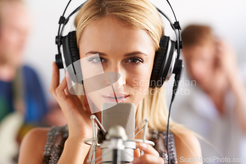 Image of Music studio, portrait and woman with microphone, headphones and band performance with talent. Singing, art and face of girl musician live streaming voice for record label, sound and audio broadcast.