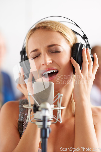 Image of Music, recording studio and woman with microphone, headphones and band performance with talent. Singing, art and happy girl musician live streaming voice for record label, sound and audio broadcast.