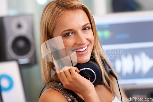 Image of Audio engineer woman, portrait and happy by pc, headphones and listening in recording studio for music. Musician, artist and producer by sound tech for wave analysis, smile or entertainment industry