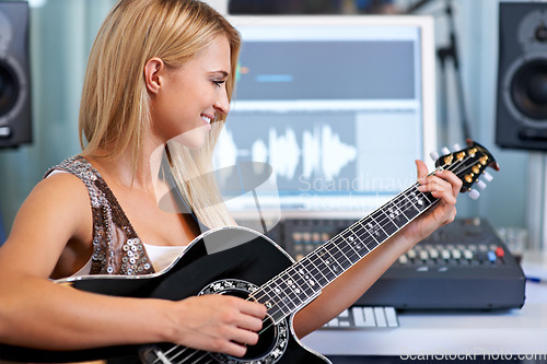 Image of Woman, guitar and computer in recording studio for music with smile, ideas and creativity for art, album or song. Musician, artist and instrument with pc for sound, audio and happy for entertainment