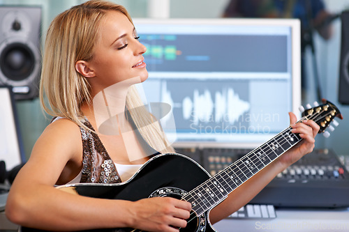 Image of Woman, guitar and creative in recording studio for music with smile, ideas and computer for art, album or song. Musician, artist and instrument with pc for sound, audio and happy for entertainment