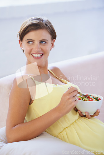 Image of Pregnant woman, salad and happy on sofa for health, nutrition and wellness in living room of apartment. Person, vegetables or smile on couch of lounge for relax, pregnancy and healthy diet with fiber