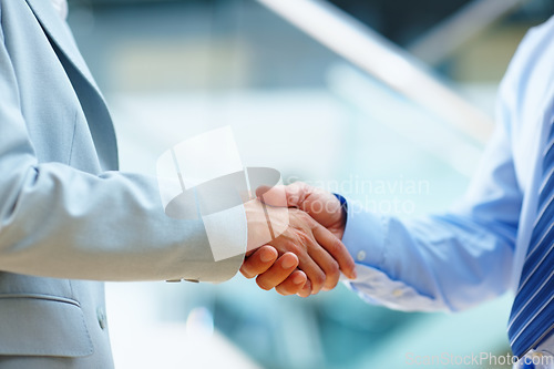 Image of Business people, shaking hands and welcome to meeting, partnership and introduction for deal at law firm in lobby. Closeup of corporate lawyer or clients handshake for success, support and consulting